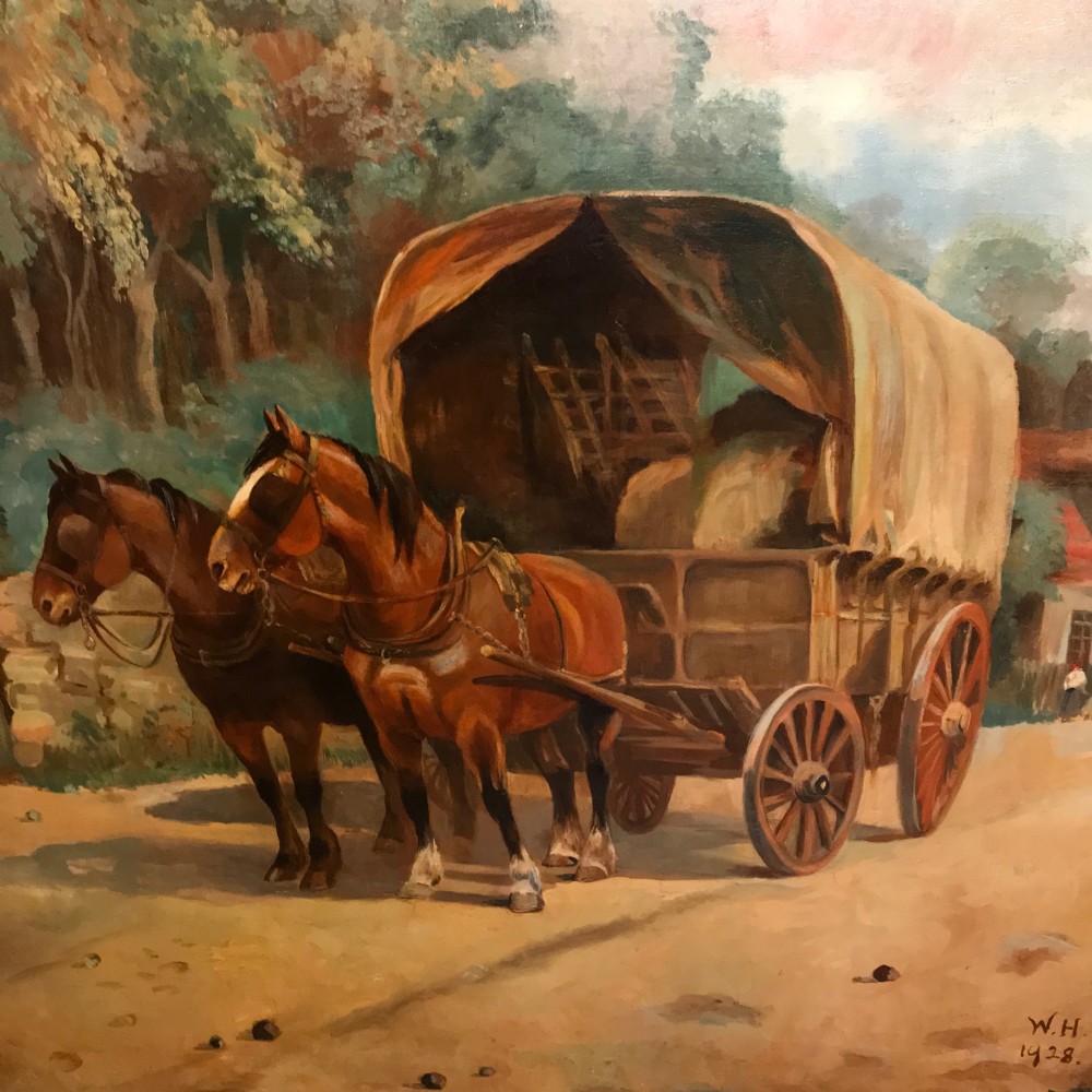 A framed oil painting depicting two brown draught horses harnessed to a covered wagon along a rural dirt road near cottages and trees. View IX