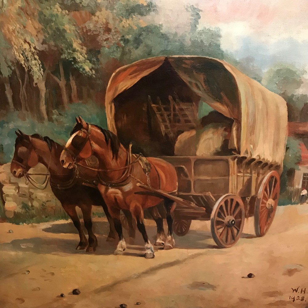 A framed oil painting depicting two brown draught horses harnessed to a covered wagon along a rural dirt road near cottages and trees. View X