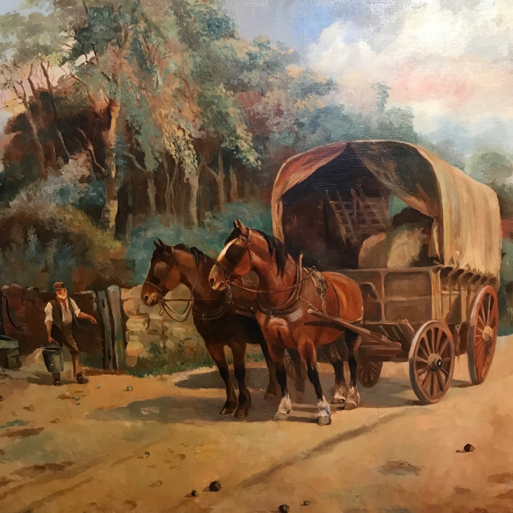 A framed oil painting depicting two brown draught horses harnessed to a covered wagon along a rural dirt road near cottages and trees. View XI