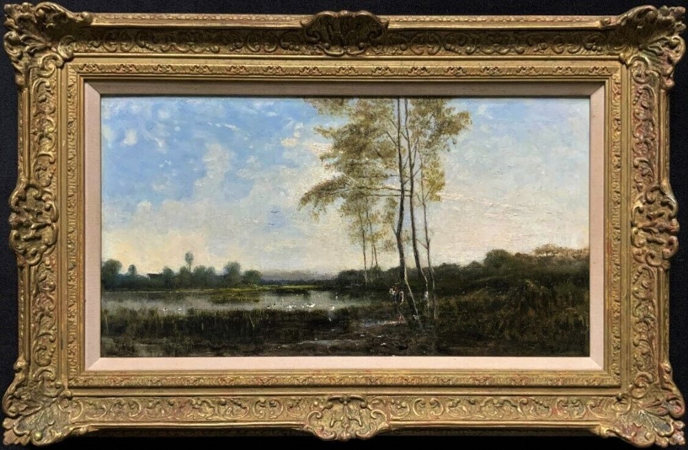 A nineteenth-century French oil landscape painting depicting slender trees beside a tranquil river under a soft sky, contained within an ornate carved gilt frame.