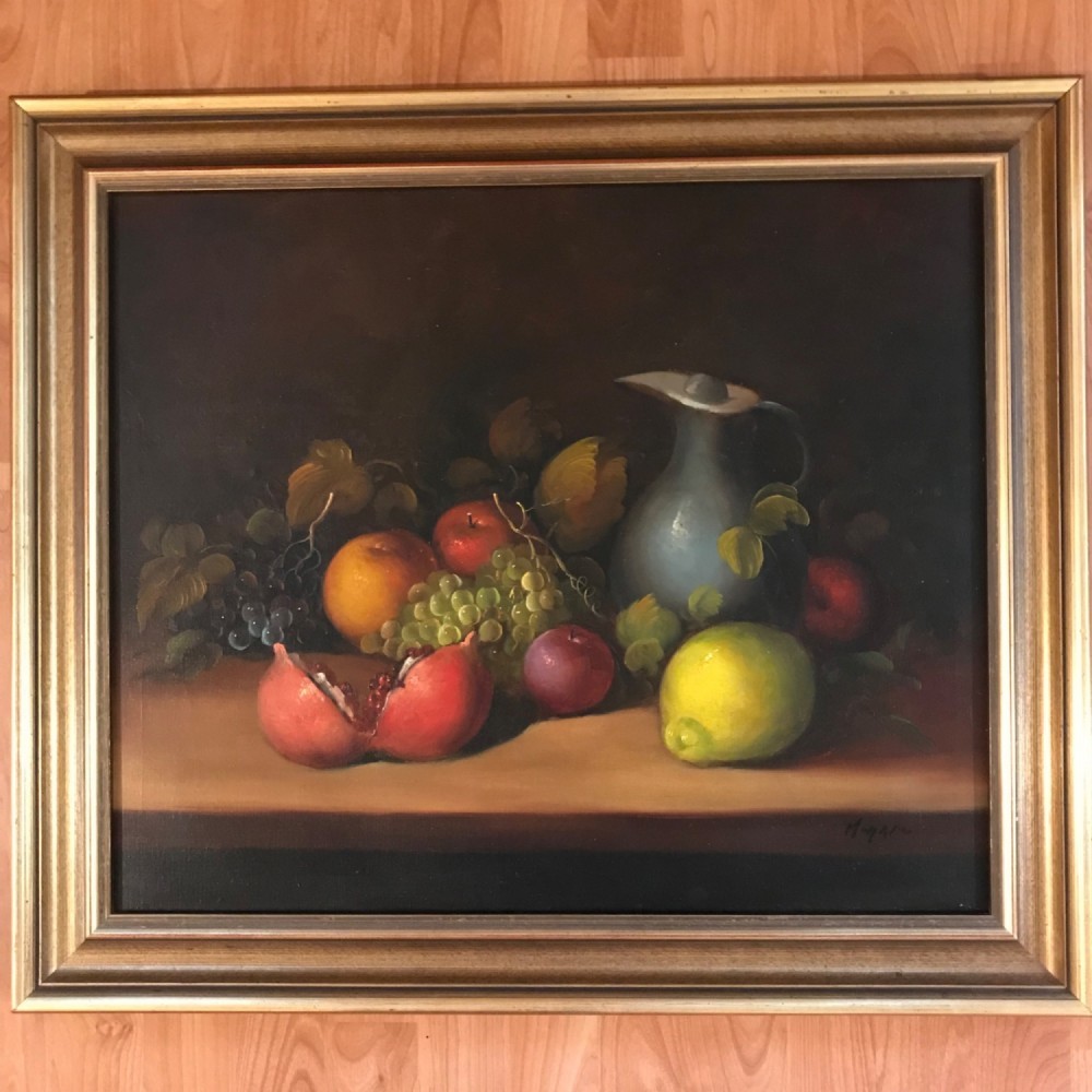 An oil painting on canvas depicting a fruit still life composition with pomegranates, grapes, apples, and a pewter jug set within a moulded gold frame. View II