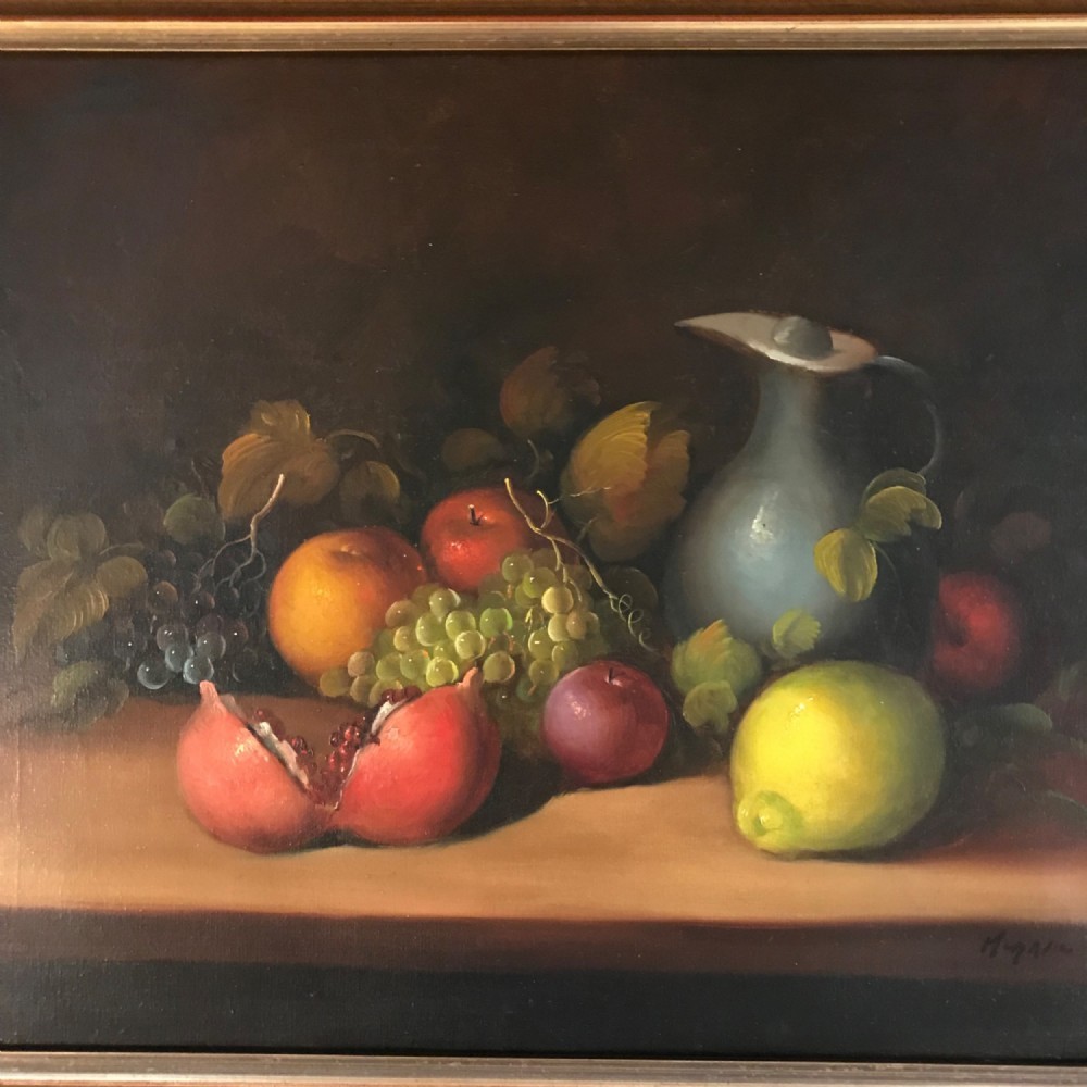 An oil painting on canvas depicting a fruit still life composition with pomegranates, grapes, apples, and a pewter jug set within a moulded gold frame. View III