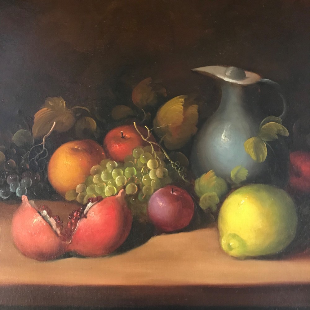An oil painting on canvas depicting a fruit still life composition with pomegranates, grapes, apples, and a pewter jug set within a moulded gold frame. View V