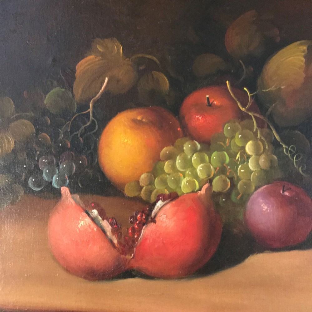 An oil painting on canvas depicting a fruit still life composition with pomegranates, grapes, apples, and a pewter jug set within a moulded gold frame. View VI