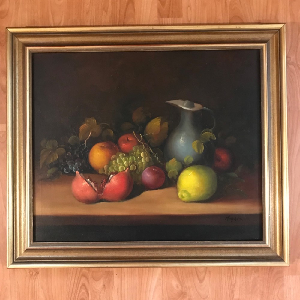 An oil painting on canvas depicting a fruit still life composition with pomegranates, grapes, apples, and a pewter jug set within a moulded gold frame. View VIII