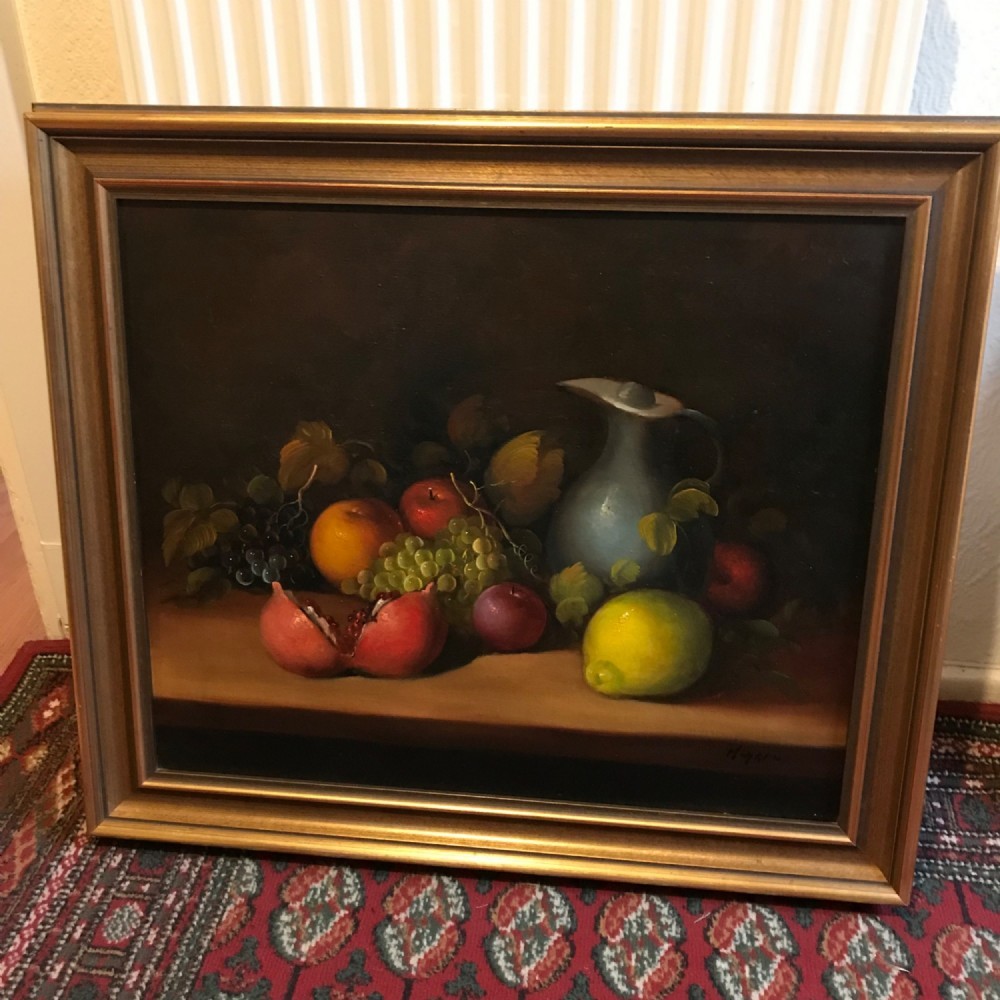 A classical still life oil painting on canvas depicting a collection of fruit, including a split pomegranate, grapes, and a lemon alongside a ceramic pitcher set against a dark background. View XIII