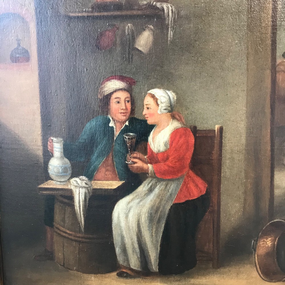 An eighteenth-century style Dutch school oil painting depicting a man and a woman seated inside a rustic tavern setting.