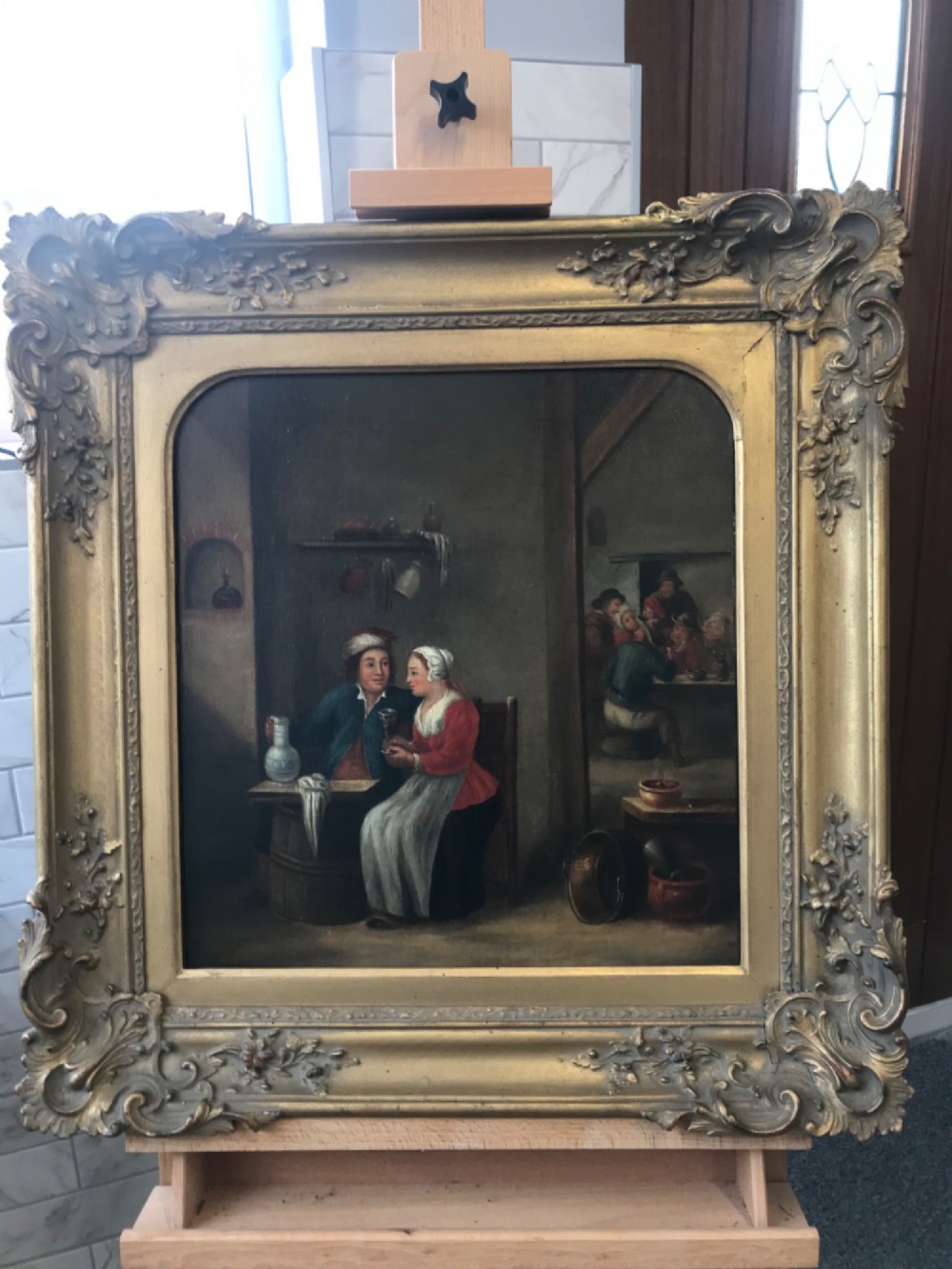 An eighteenth-century style Dutch school oil painting depicting a man and a woman seated inside a rustic tavern setting. View VIII