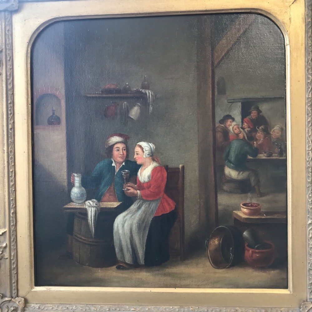 An 18th-century style oil painting depicting figures inside a tavern interior, set within a carved gold giltwood frame. View III