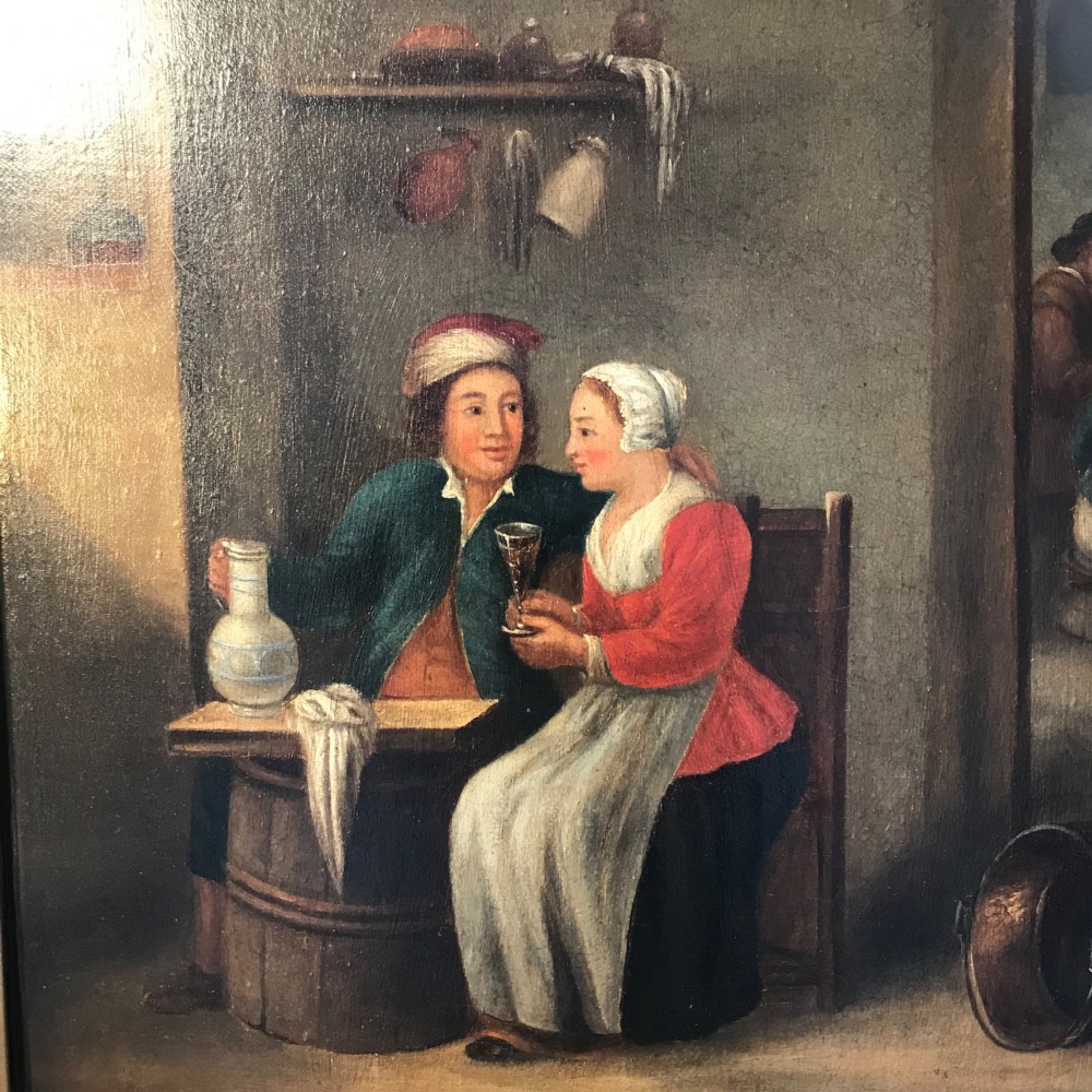 An 18th-century style oil painting depicting figures inside a tavern interior, set within a carved gold giltwood frame. View XII