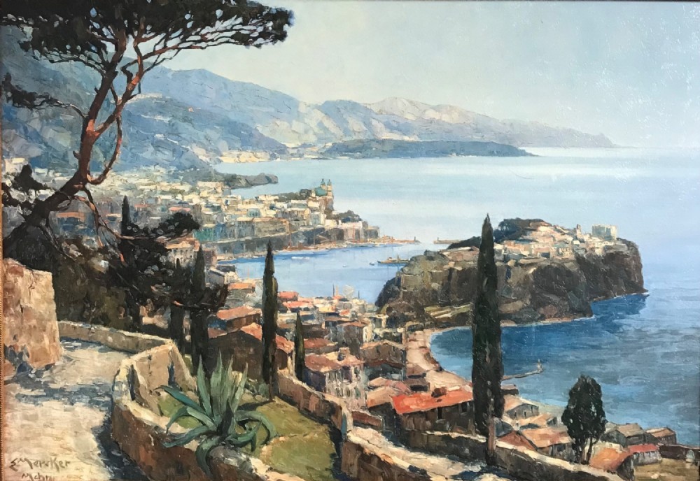 A large framed landscape print depicting a coastal vista of Monaco with cypress trees and stone walls overlooking the sea, set within a gilded frame. View IV