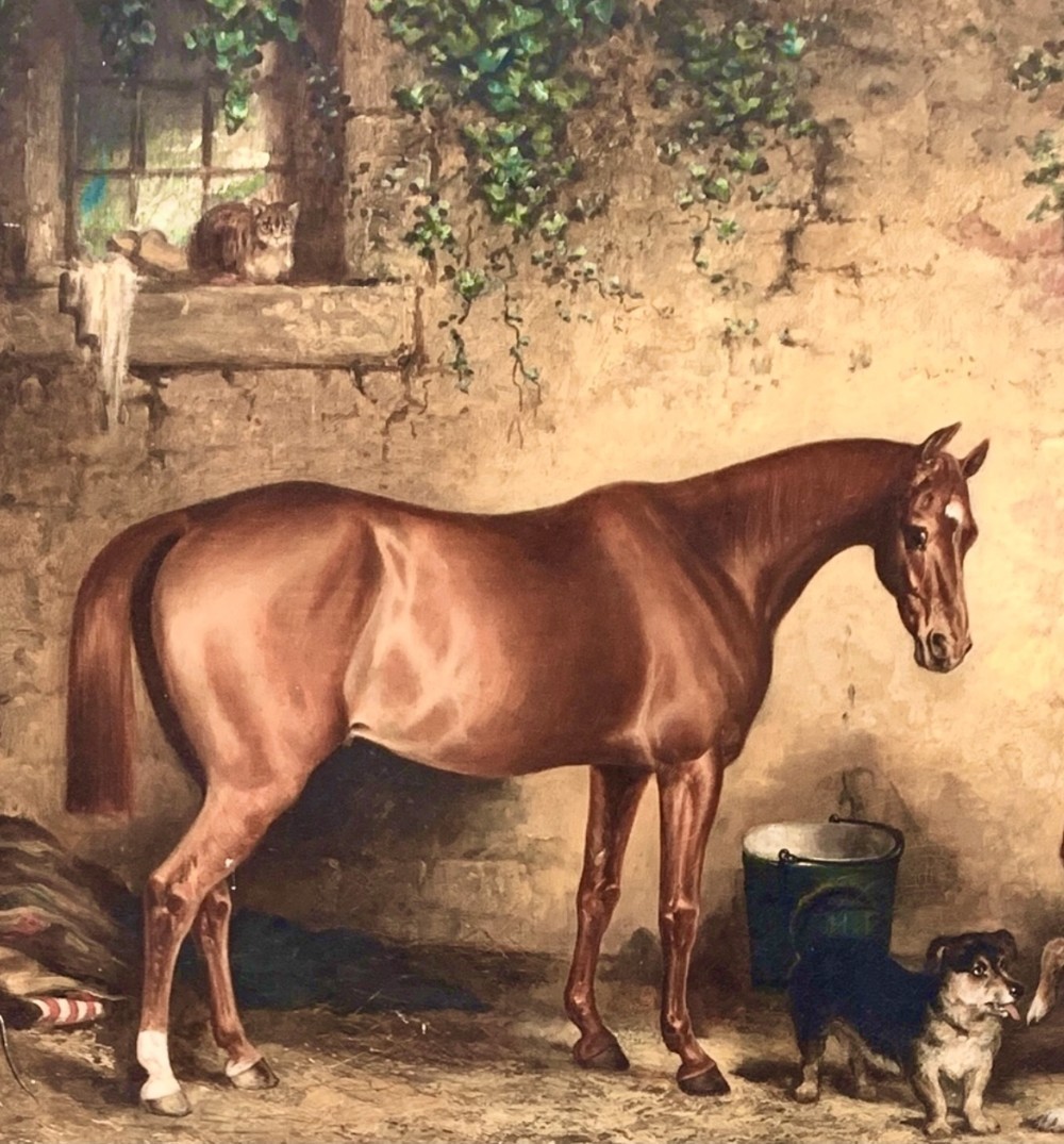 A 19th-century oil painting on canvas portraying a brown bay hunter horse inside a stone stable with two dogs, presented in an ornate gilt frame. View II
