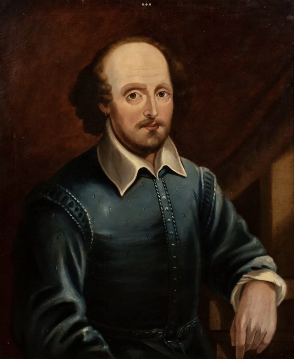 A 19th-century oil painting depicting William Shakespeare wearing a blue doublet with a white turn-down collar, presented in a gold-finished frame. View VIII