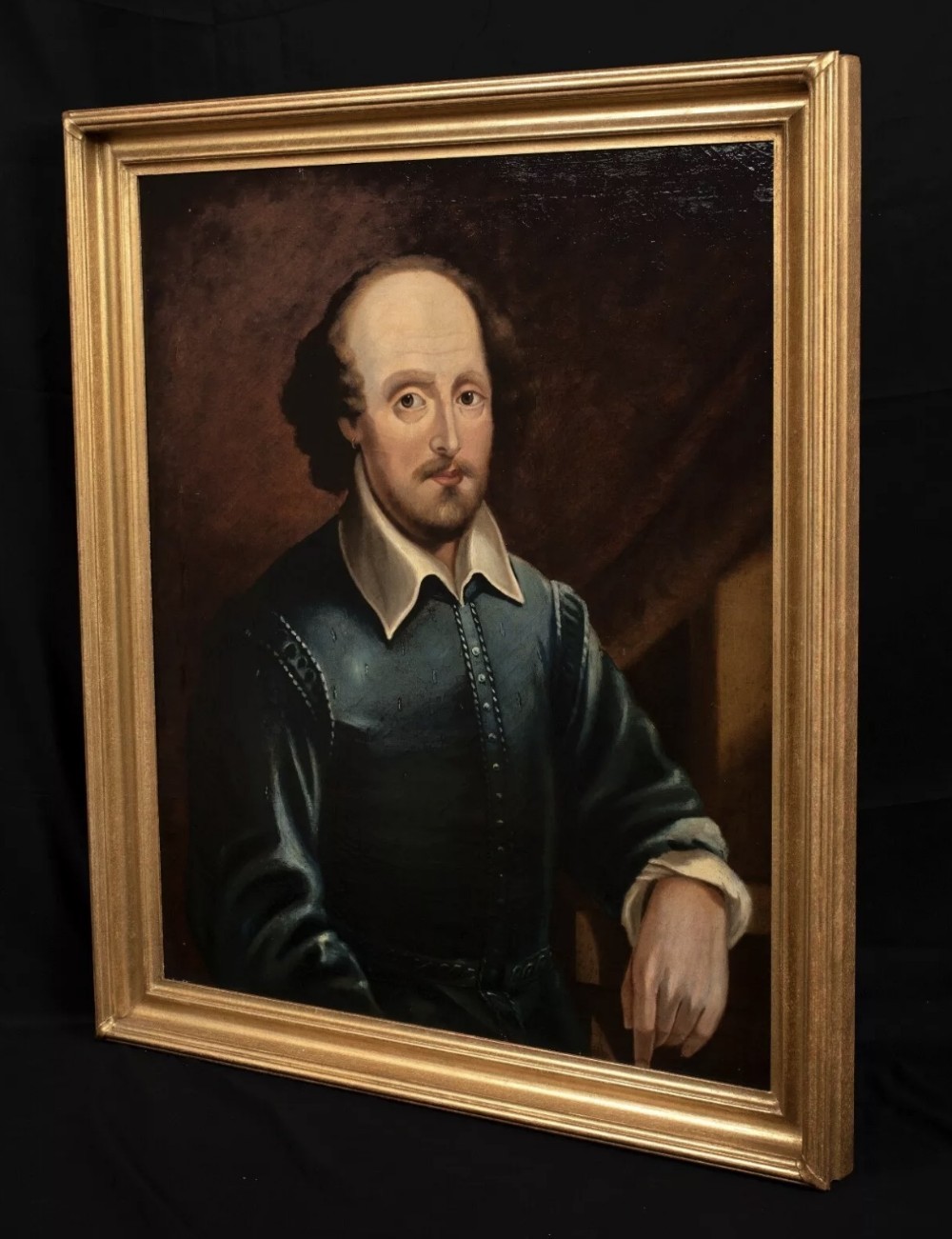 A 19th-century oil painting depicting William Shakespeare wearing a blue doublet with a white turn-down collar, presented in a gold-finished frame. View IX