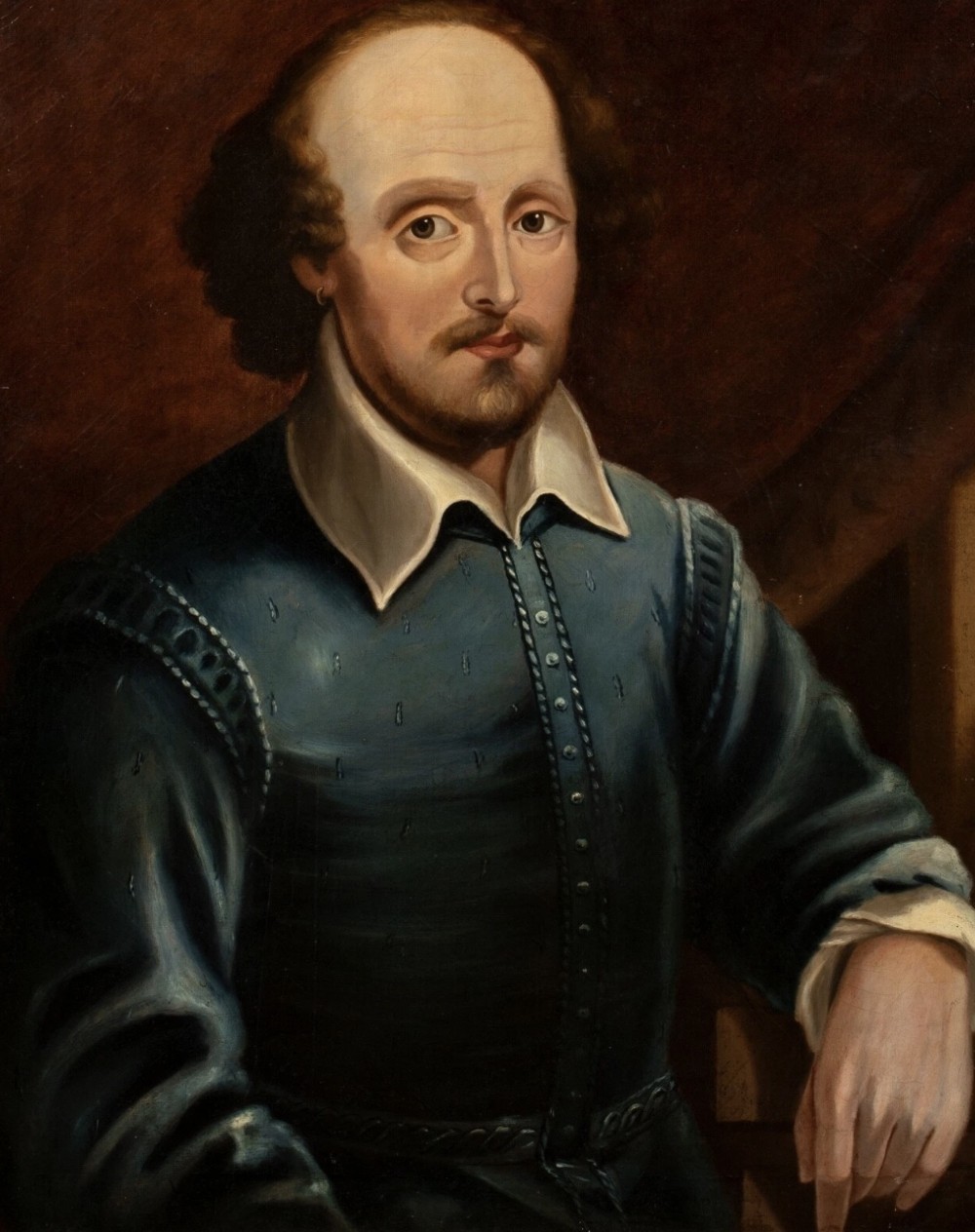 A 19th-century oil painting depicting William Shakespeare wearing a blue doublet with a white turn-down collar, presented in a gold-finished frame. View XI