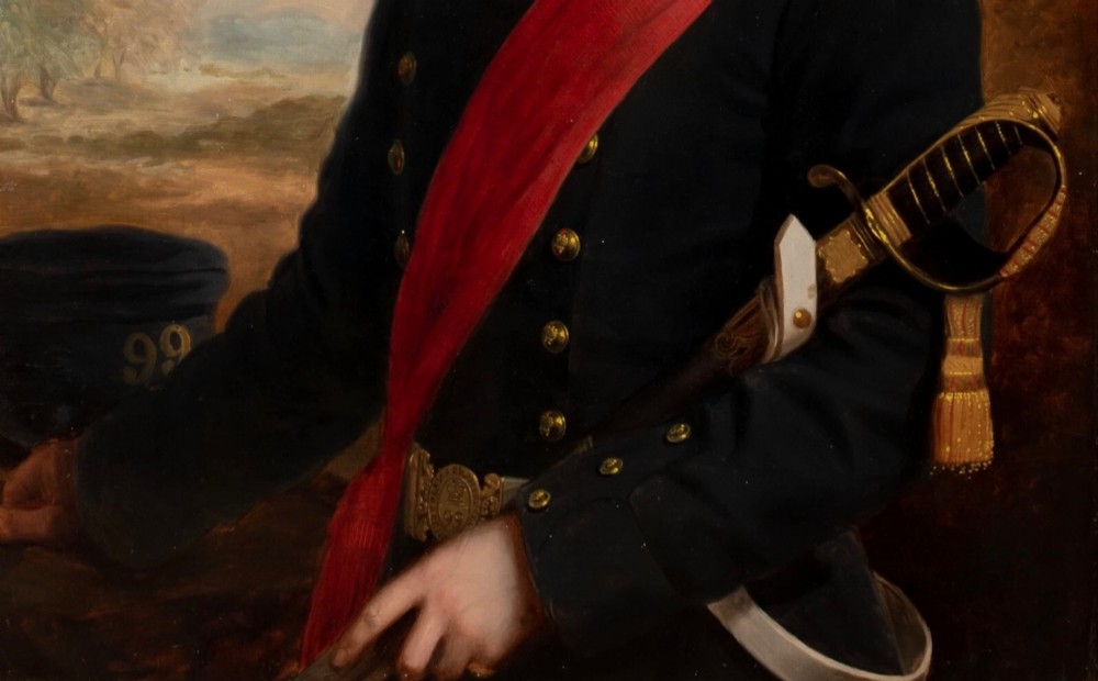 A nineteenth-century oil painting on canvas depicting a young military officer in a dark uniform with a red sash and sword, set within an ornate gilded frame. View IV