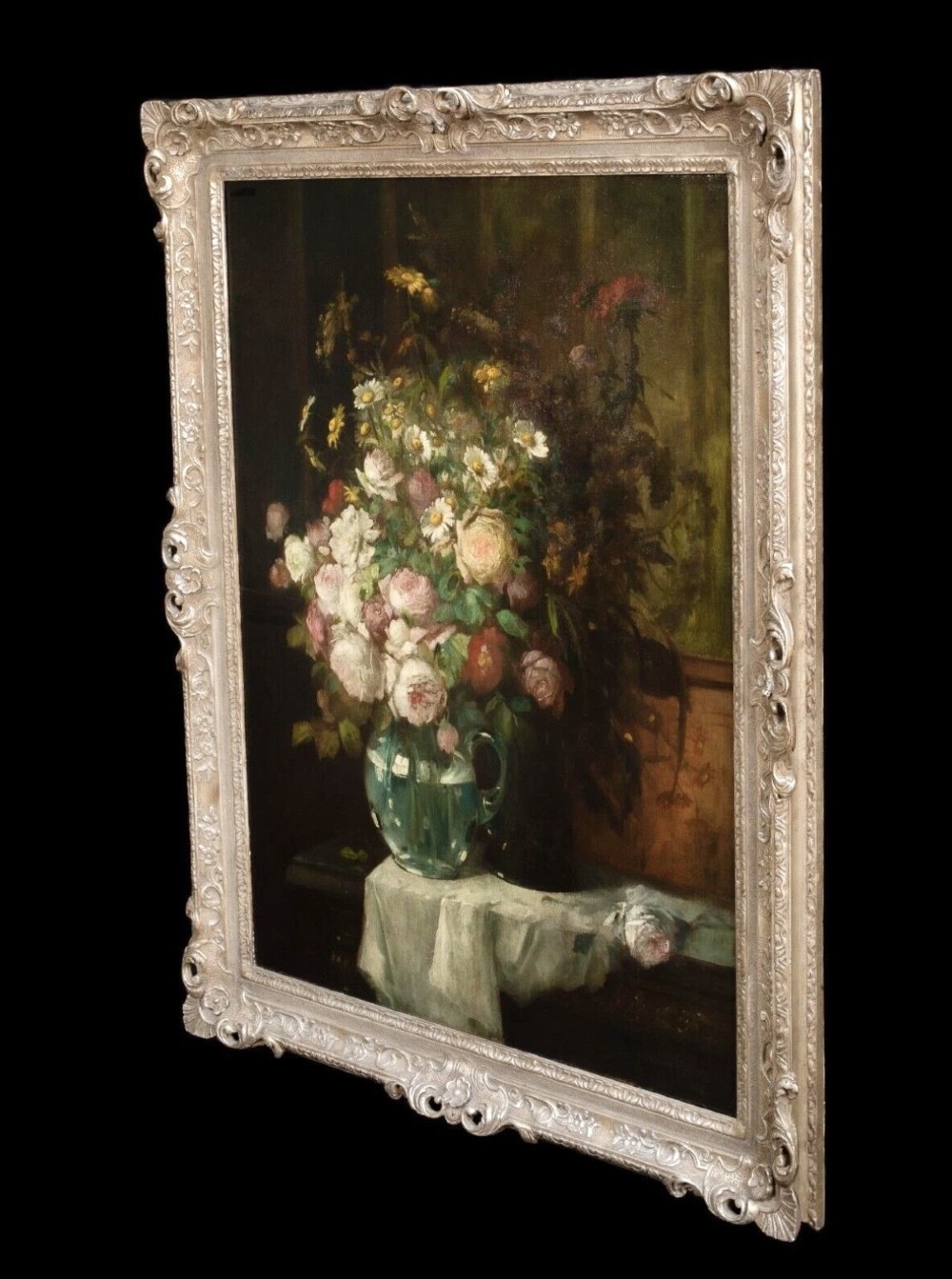 A 19th-century floral oil painting depicting a bouquet of pink and white flowers in a green glass pitcher, presented within an ornate silvered carved frame. View IV