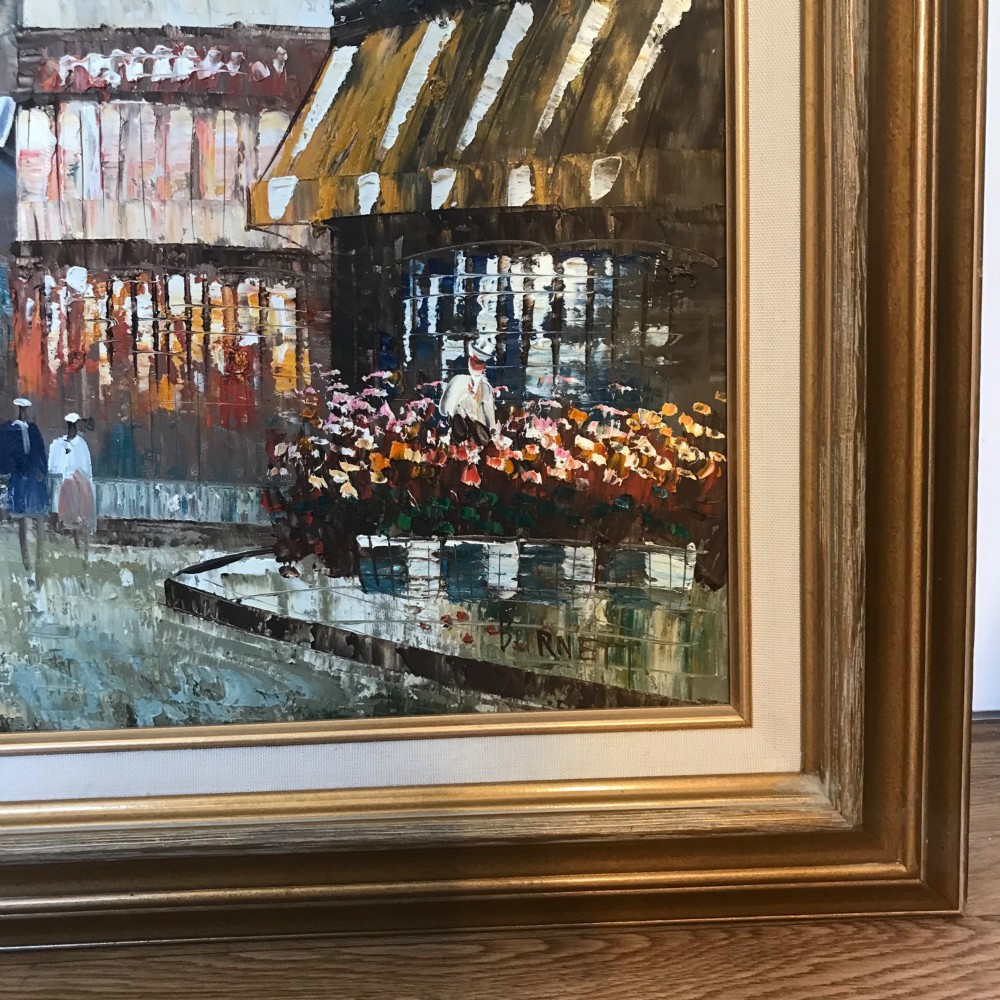 A large framed impressionist oil painting depicting a bustling Parisian street scene with buildings, figures, and the Eiffel Tower under a bright blue sky. View V