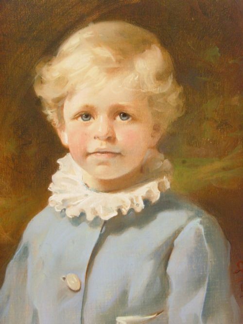 An oval 19th-century pastel portrait of a young boy with blond hair wearing a blue jacket, presented in a moulded gilt frame. View XI