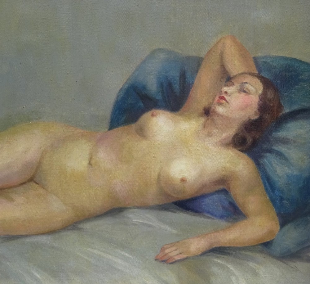 A framed French Art Deco oil painting on canvas depicting a reclining female nude resting against a blue pillow. View II