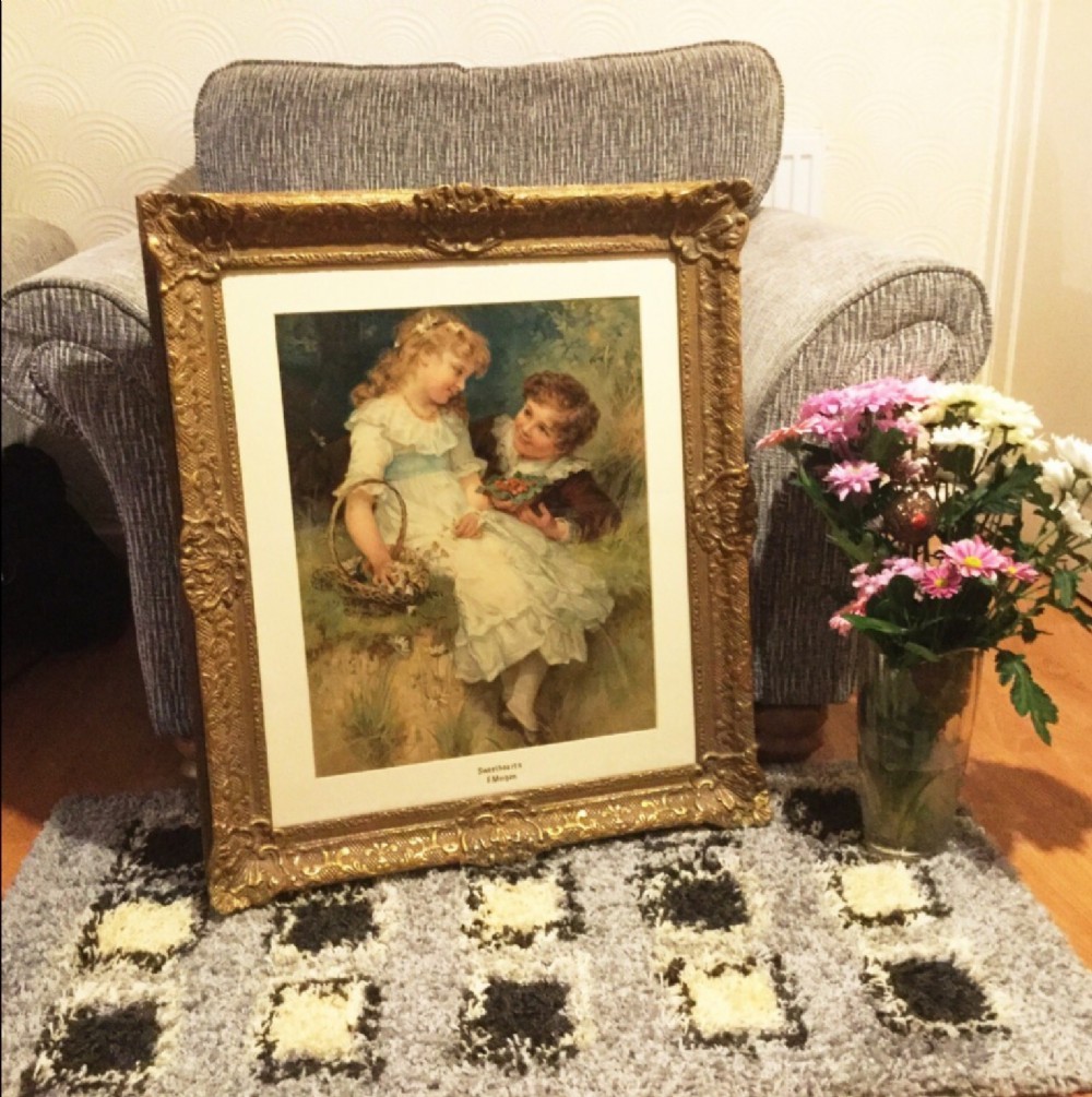 An antique framed colour print titled Sweethearts after Frederick Morgan, depicting two children sitting outdoors within an ornate gilded frame. View II