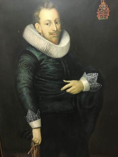 A pair of large, dark-framed full-length oil-style portrait paintings depicting a 17th-century Dutch man and woman wearing traditional white ruffs. View VII