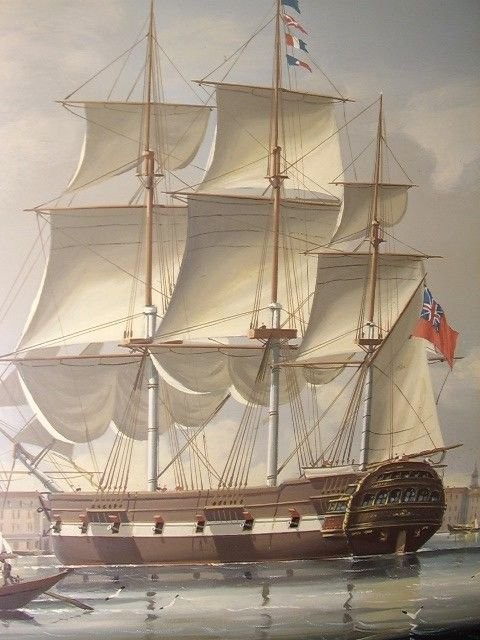 A 19th-century style marine oil painting on panel depicting a large sailing warship anchored near a stone coastal fortification under a cloudy sky, presented in a heavily moulded gold gilt frame. View XI