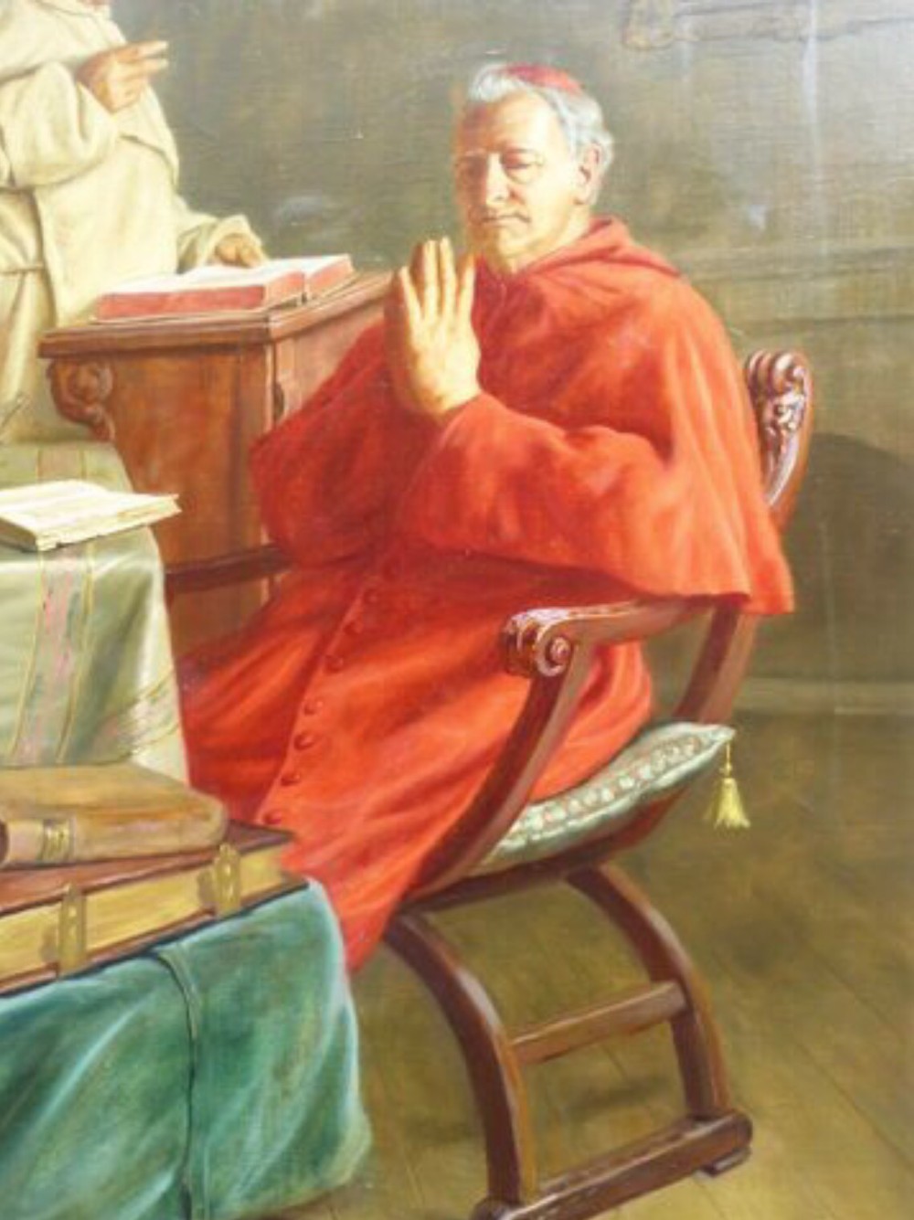 A 19th-century framed oil painting depicting a Vatican cardinal in red robes sitting in prayer beside a monk at a book-laden table. View IV