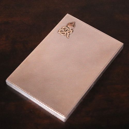 fig 2. An engine-turned silver and gold mounted Cartier notelet case presented inside an open red leather fitted box alongside written correspondence.