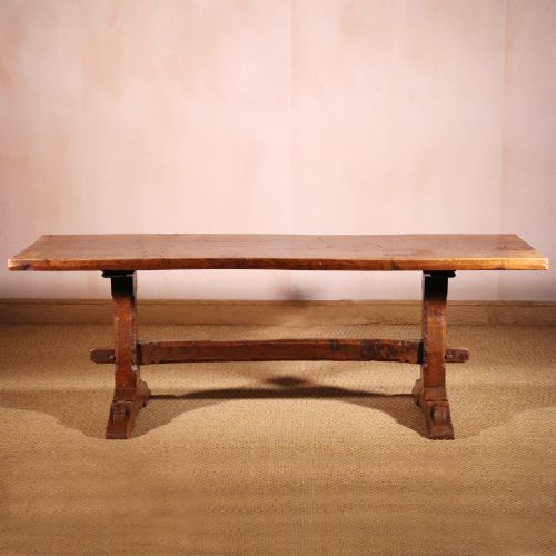 fig 1. A handcrafted oak trestle dining table featuring an adzed tabletop, keyed stretcher joint, and two matching solid oak benches.