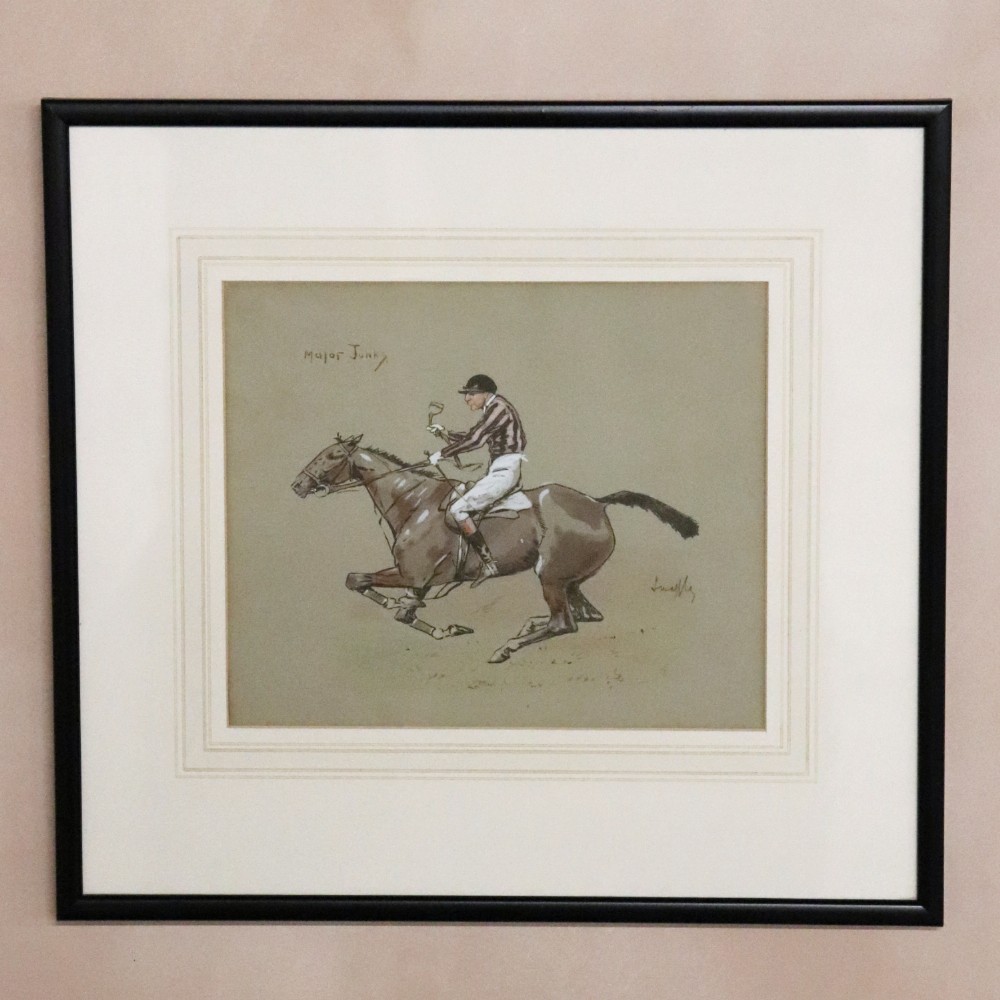 A framed equestrian print depicting a jockey riding a brown horse, titled Major Junks and signed Snaffles, presented in a cream mount and black frame.