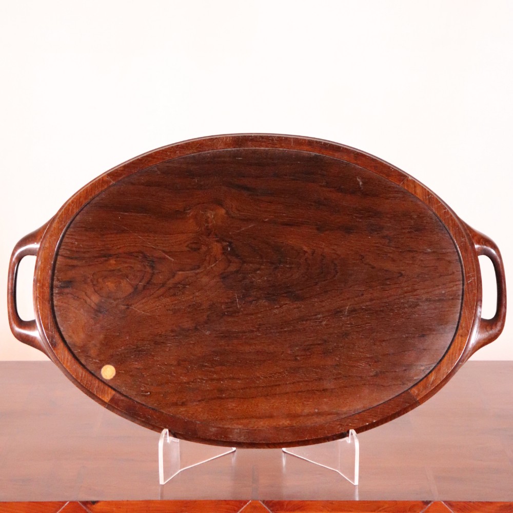 An oval antique tray featuring a central sunburst parquetry design of contrasting specimen woods with carved side handles. View IX