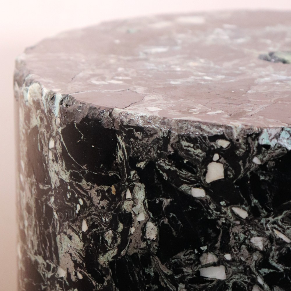 An early nineteenth-century cylindrical scagliola column pedestal with a dark green speckled faux-marble finish resting on a moulded off-white circular base. View III