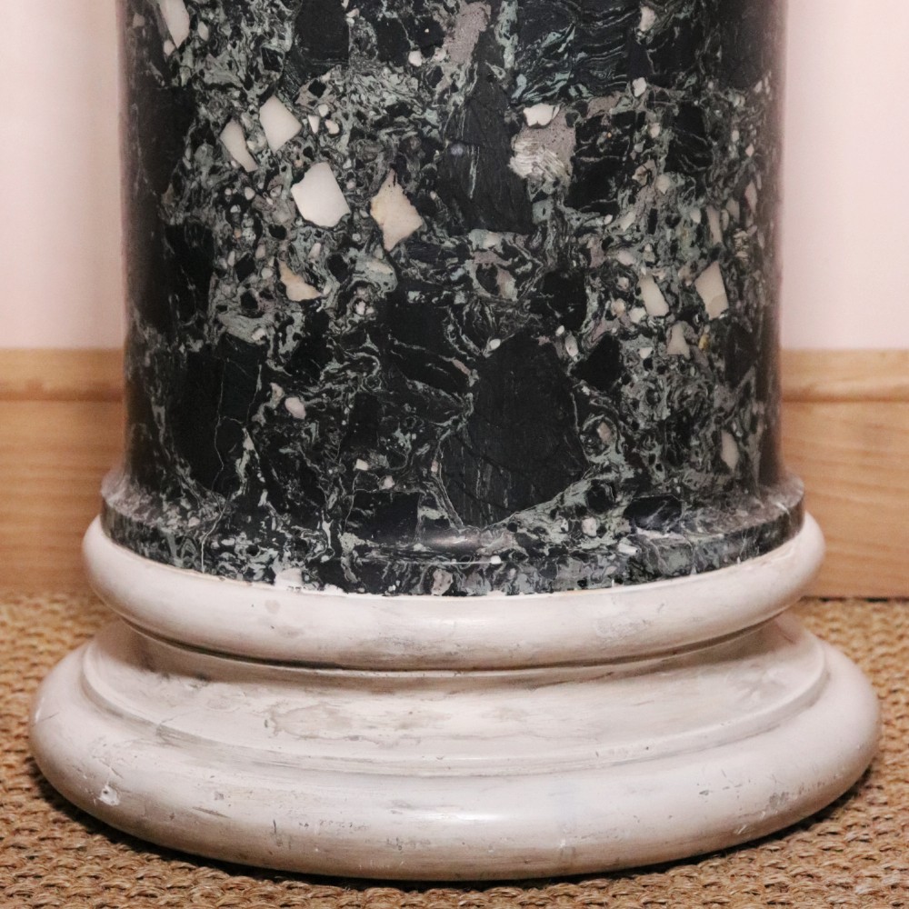 An early nineteenth-century cylindrical scagliola column pedestal with a dark green speckled faux-marble finish resting on a moulded off-white circular base. View IV