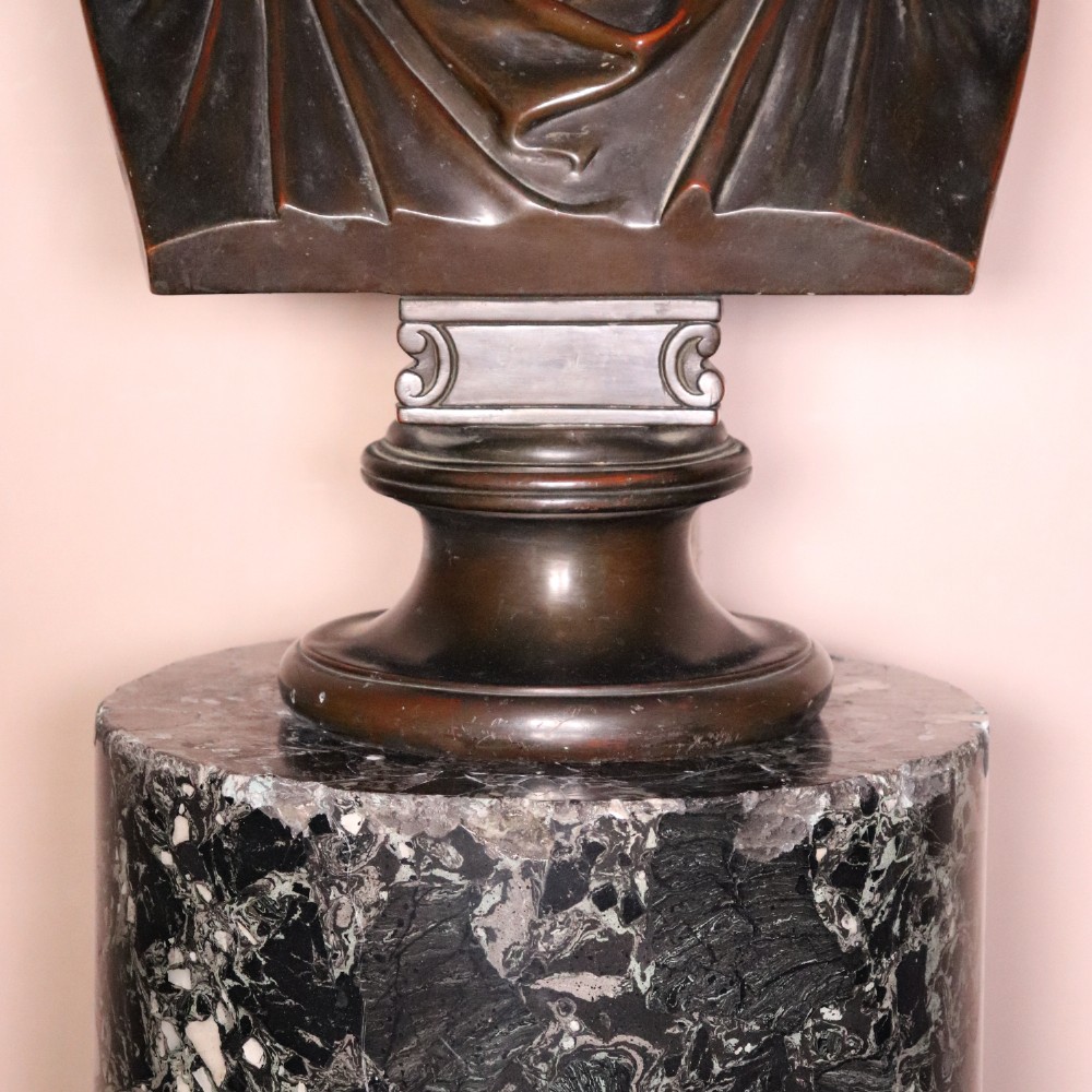 An early nineteenth-century cylindrical scagliola column pedestal with a dark green speckled faux-marble finish resting on a moulded off-white circular base. View VIII