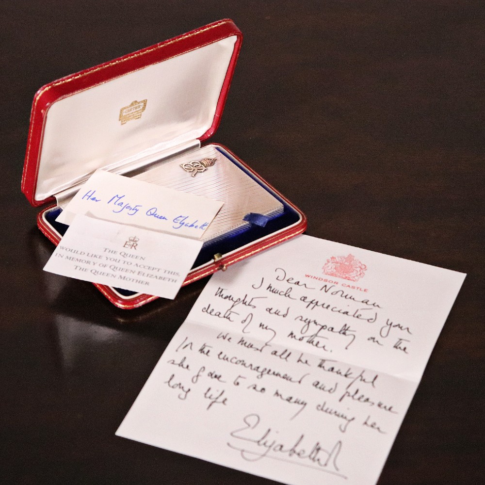 An engine-turned silver and gold mounted Cartier notelet case presented inside an open red leather fitted box alongside written correspondence.