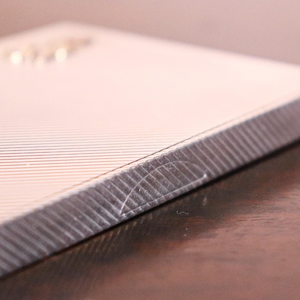An engine-turned silver and gold mounted Cartier notelet case presented inside an open red leather fitted box alongside written correspondence. View V