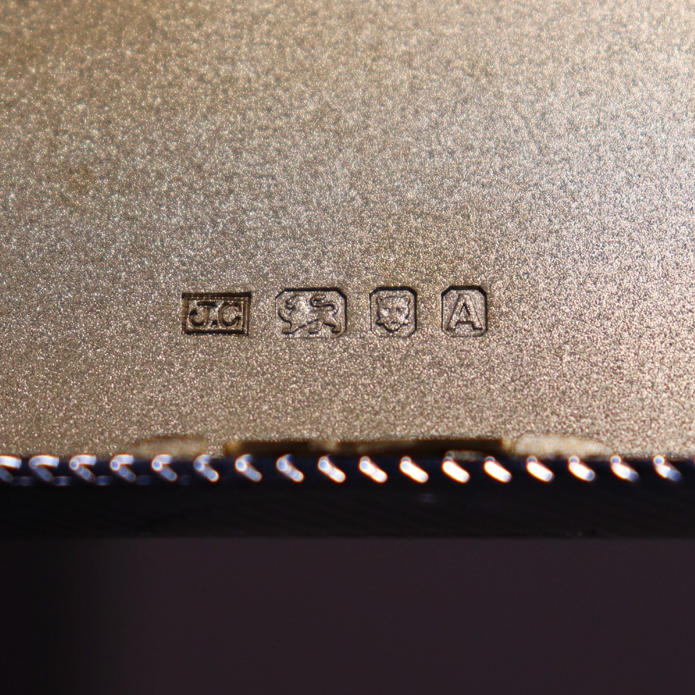 An engine-turned silver and gold mounted Cartier notelet case presented inside an open red leather fitted box alongside written correspondence. View IX
