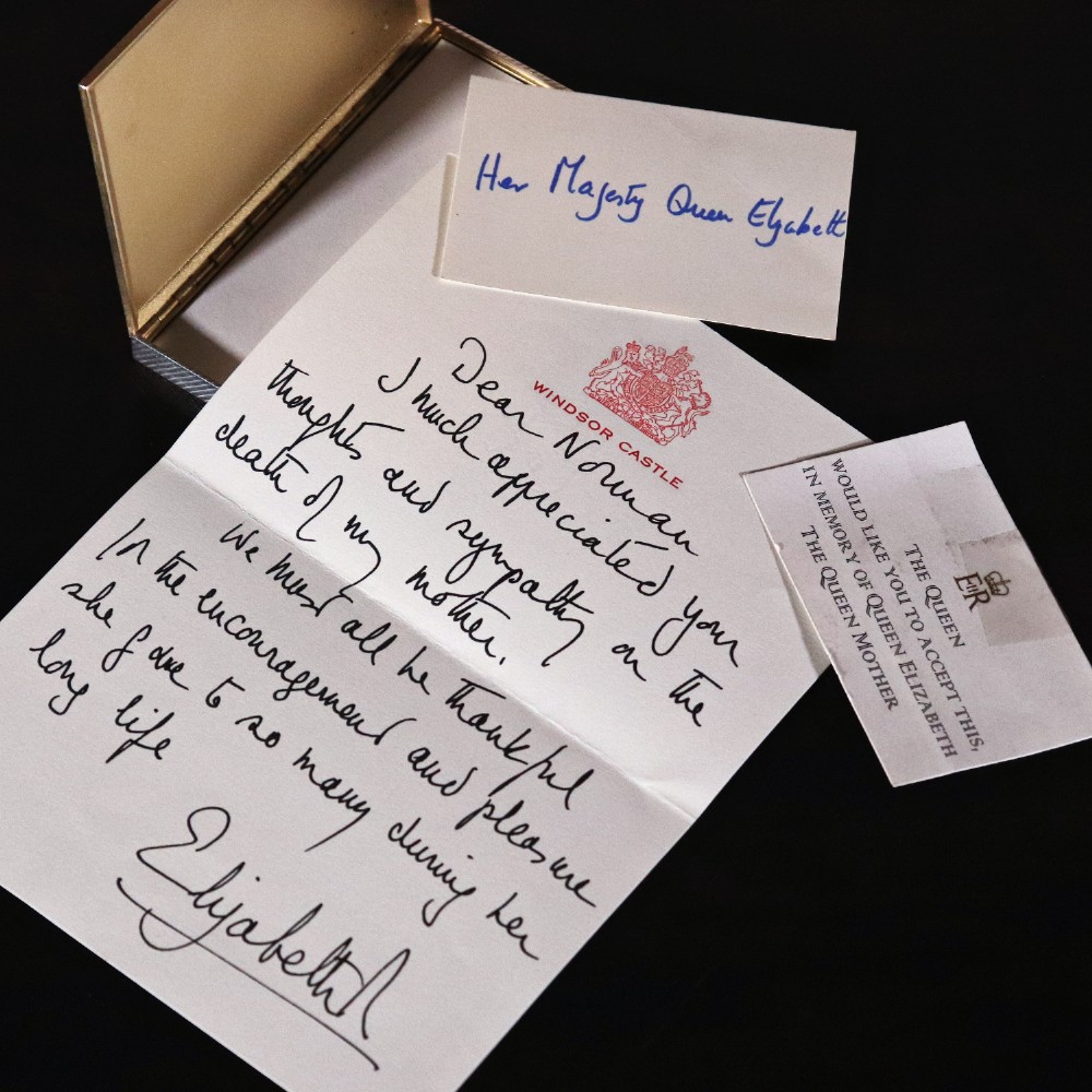 An engine-turned silver and gold mounted Cartier notelet case presented inside an open red leather fitted box alongside written correspondence. View X