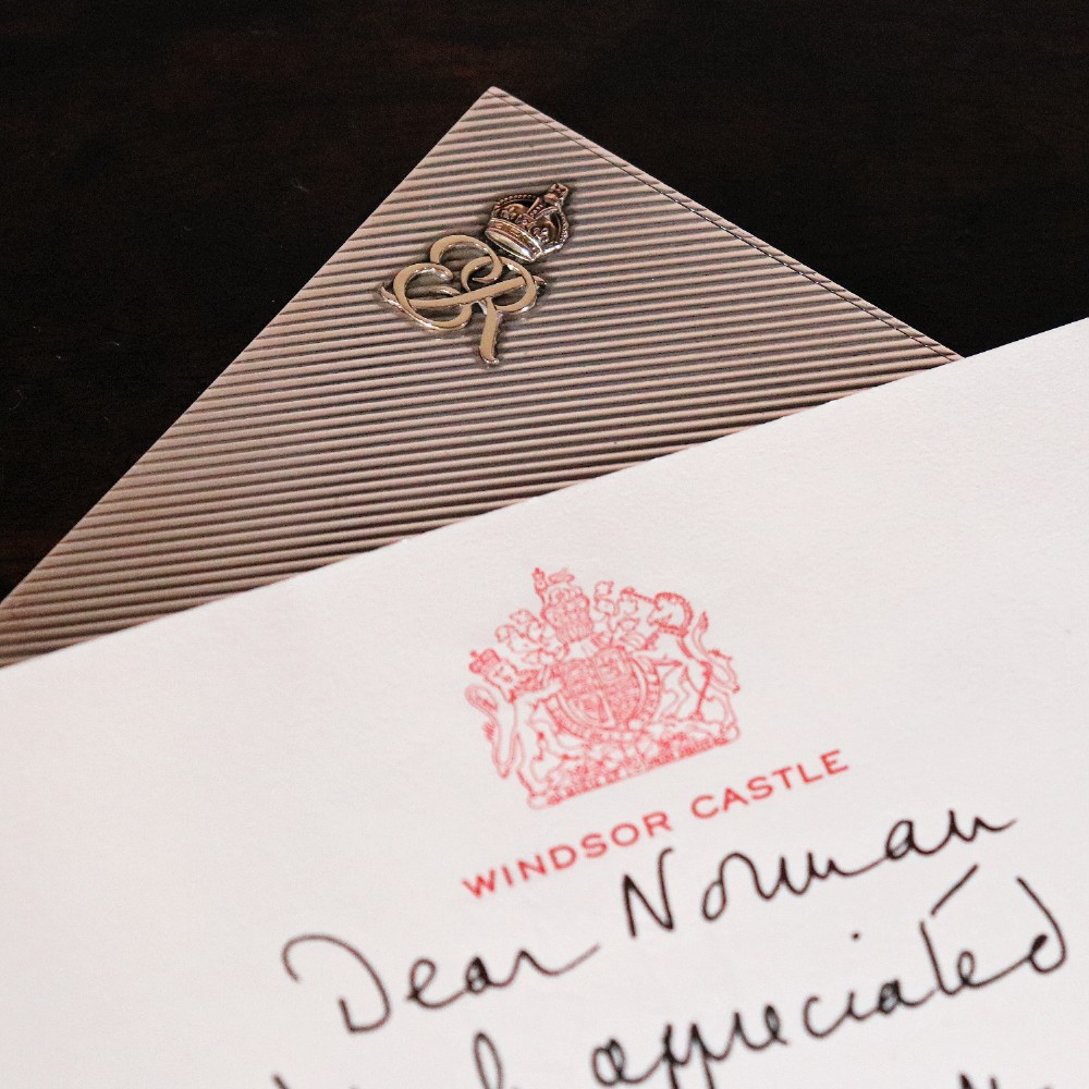 An engine-turned silver and gold mounted Cartier notelet case presented inside an open red leather fitted box alongside written correspondence. View XI