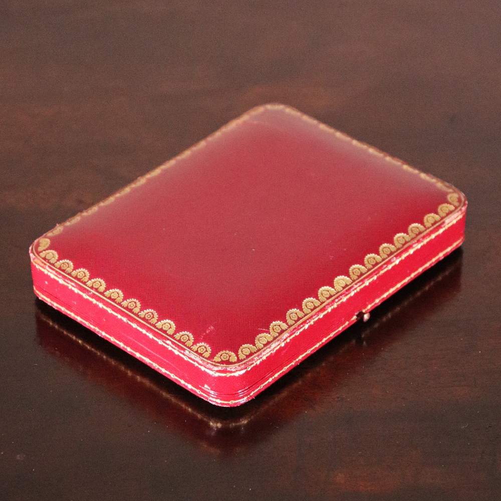 An engine-turned silver and gold mounted Cartier notelet case presented inside an open red leather fitted box alongside written correspondence. View XIV