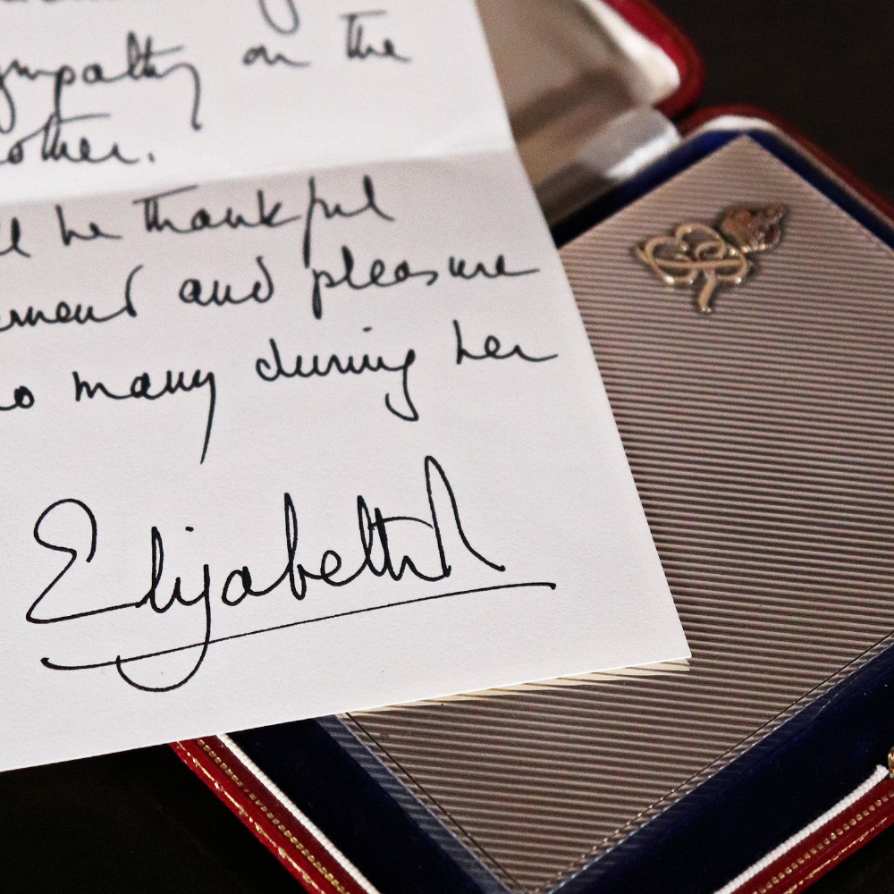 An engine-turned silver and gold mounted Cartier notelet case presented inside an open red leather fitted box alongside written correspondence. View XV