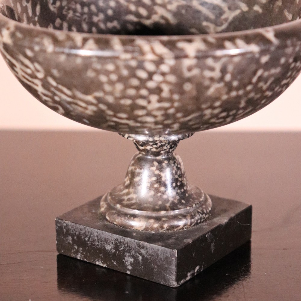 A small nineteenth-century tazza carved from dark Ashford coral marble with visible light fossil inclusions, featuring a shallow round bowl on a turned pedestal and square plinth base. View IV