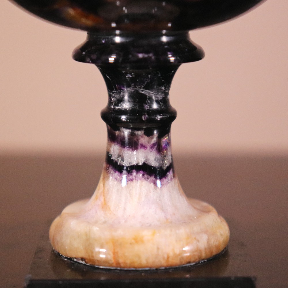 A small 19th-century Blue John fluorite tazza with purple and yellow banding, mounted on a turned stem and a square black marble base. View IV