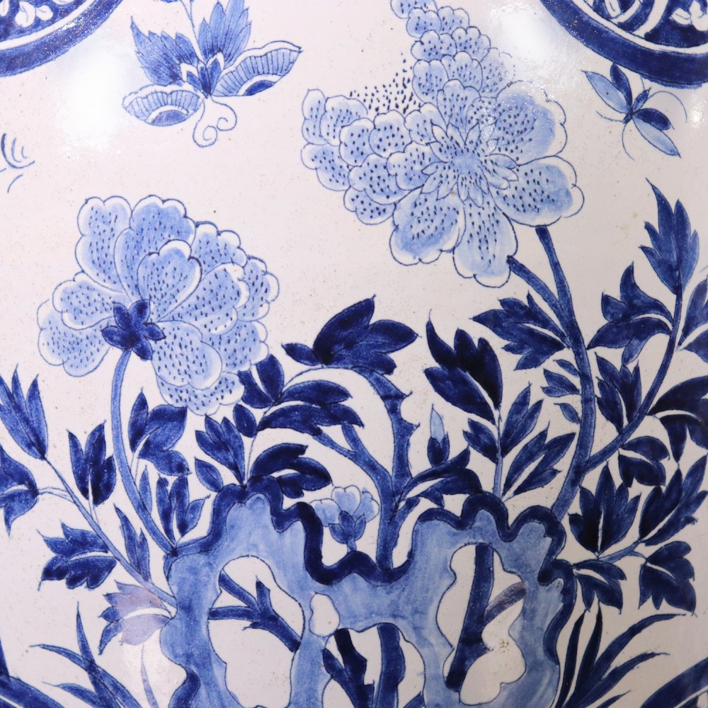 A pair of Chinese style blue and white porcelain ginger jar table lamps featuring floral panels mounted on dark wooden bases. View IV