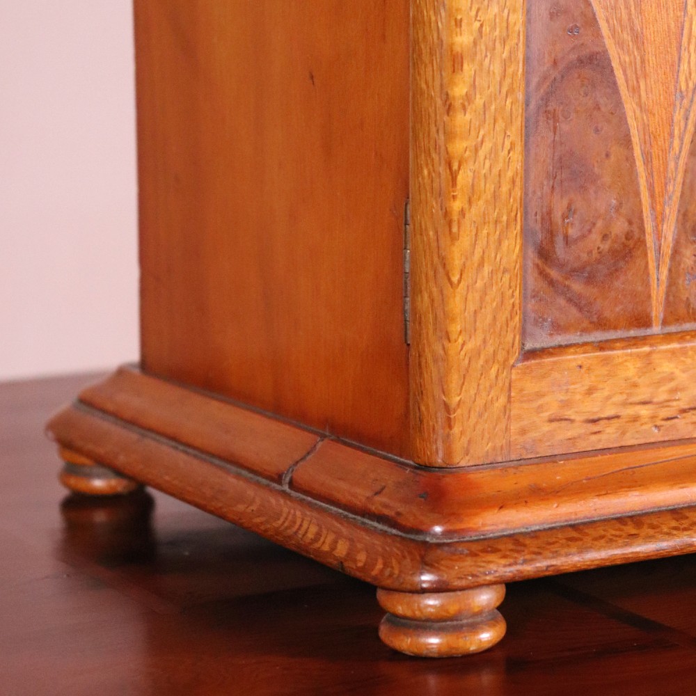A 19th-century wooden table cabinet with two doors featuring inlaid star motifs set within pointed arches, resting on turned bun feet. View III
