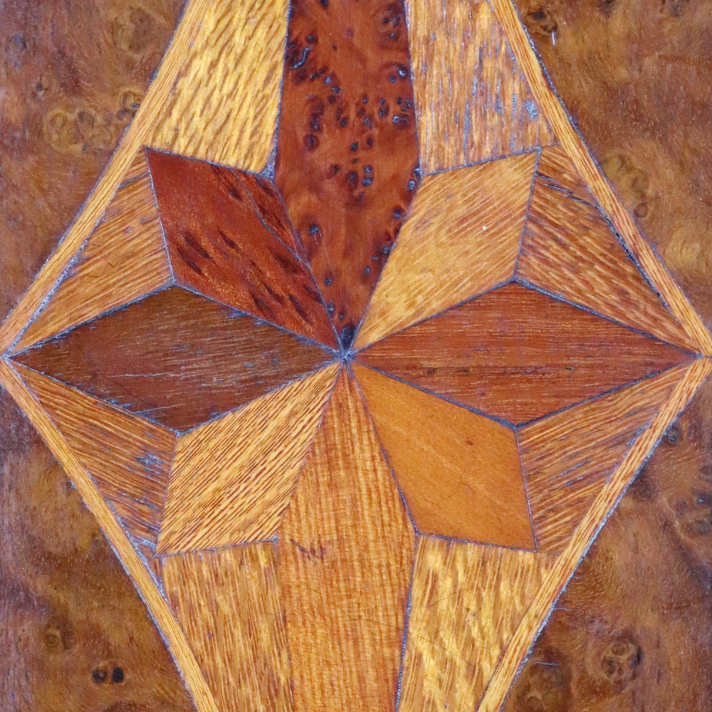 A 19th-century wooden table cabinet with two doors featuring inlaid star motifs set within pointed arches, resting on turned bun feet. View IV