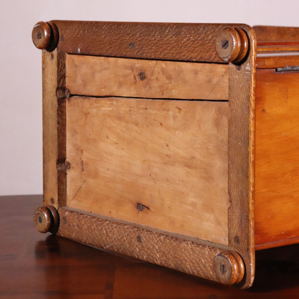 A 19th-century wooden table cabinet with two doors featuring inlaid star motifs set within pointed arches, resting on turned bun feet. View X