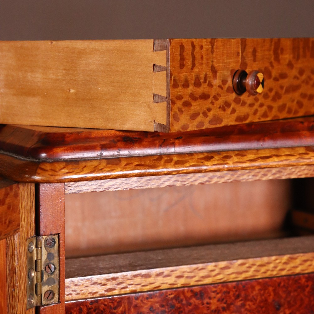 A 19th-century wooden table cabinet with two doors featuring inlaid star motifs set within pointed arches, resting on turned bun feet. View XIV
