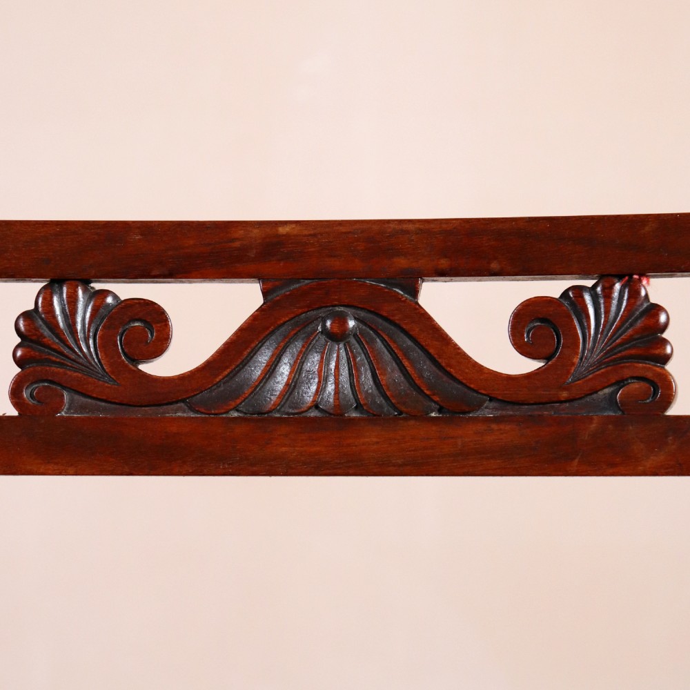 A set of six Regency period side chairs crafted from dark Goncalo Alves timber featuring carved crest rails, detailed backsplats, turned front legs, and hand-woven cane seats. View VII